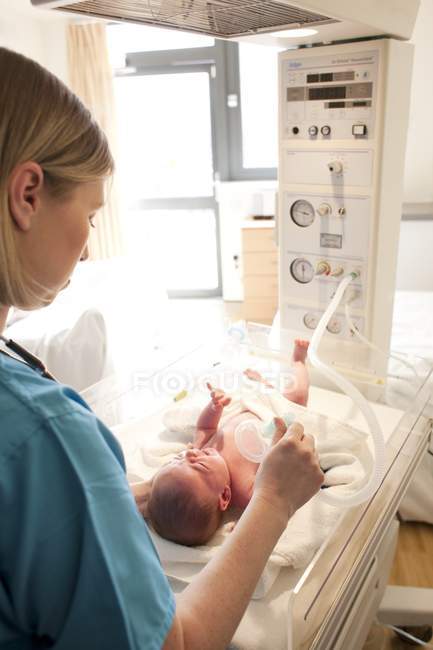 Медсестра дает кислород новорожденному ребенку . — стоковое фото