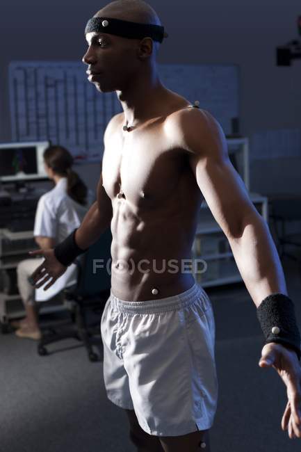 Athlete with sensors exercising — Stock Photo
