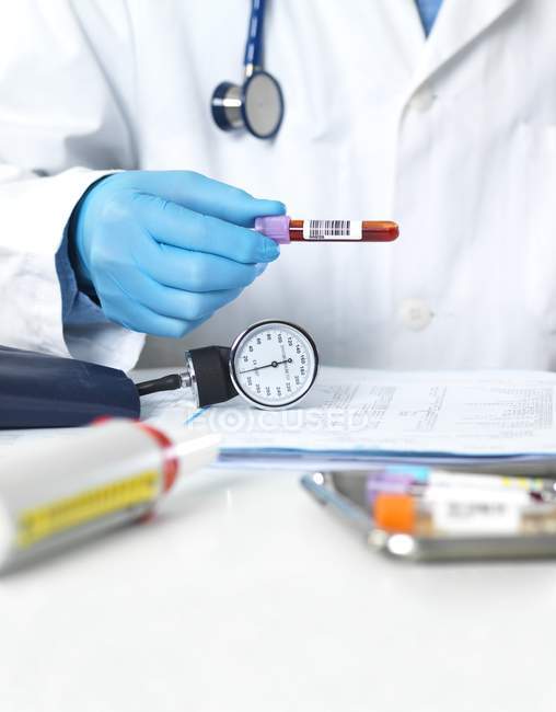 Cropped view of doctor holding vial of blood for testing. — Stock Photo