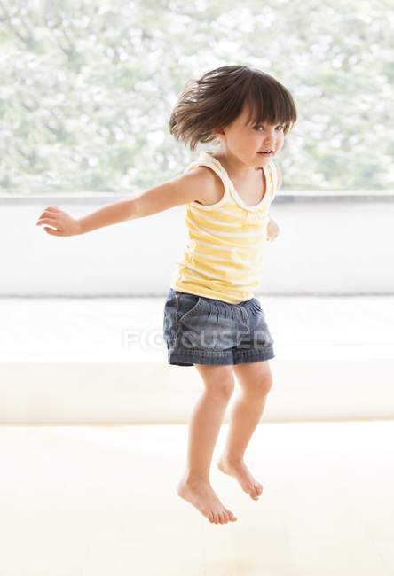 Toddler girl jumping — Stock Photo