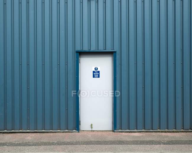 Fire escape exit in metal clad industrial building. — Stock Photo