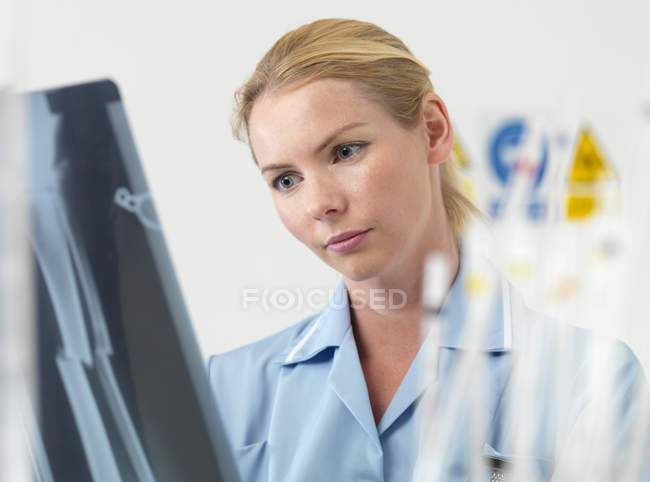 Radiologa donna esaminando l'immagine a raggi X . — Foto stock