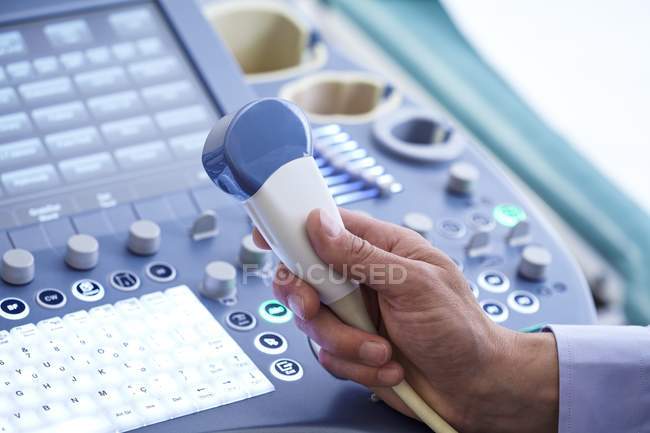 Male hand holding ultrasound transducer. — Stock Photo