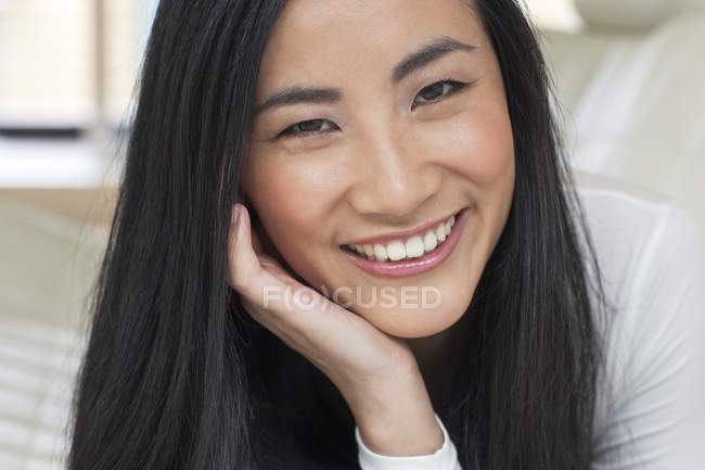 Mid adult woman smiling with hand on chin, portrait. — Stock Photo