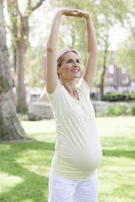 Pregnant woman stretching — Stock Photo