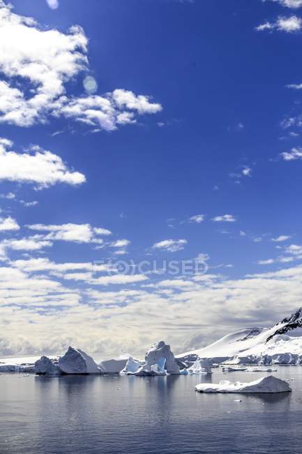 Mountains rising above shores of entrance of Lemaire Channel in Antarctic Peninsula. — Stock Photo