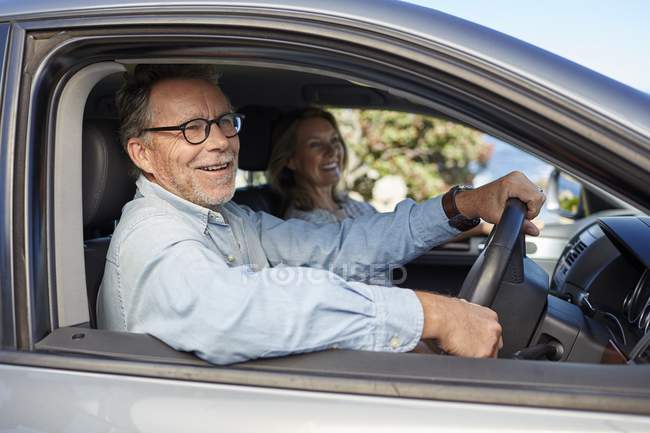 Senior couple sitting in car and smiling. — Stock Photo