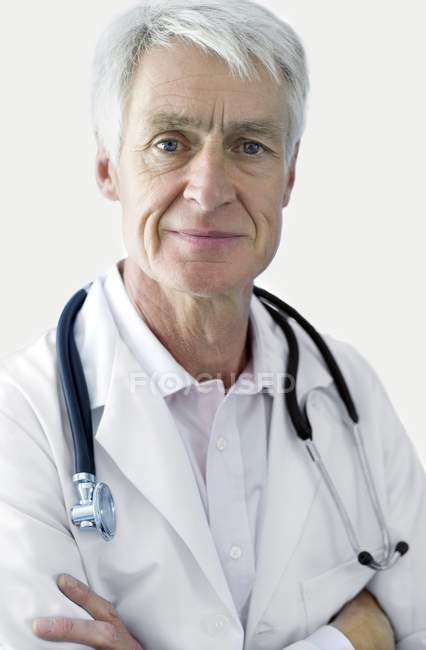 Portrait of senior doctor with arms folded. — Stock Photo