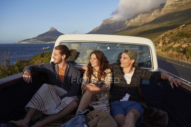 Friends riding in pick up truck and looking away. — Stock Photo