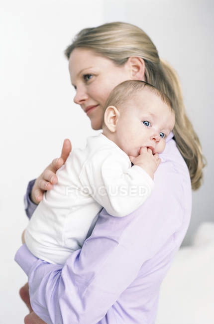 Mother holding baby daughter. — Stock Photo