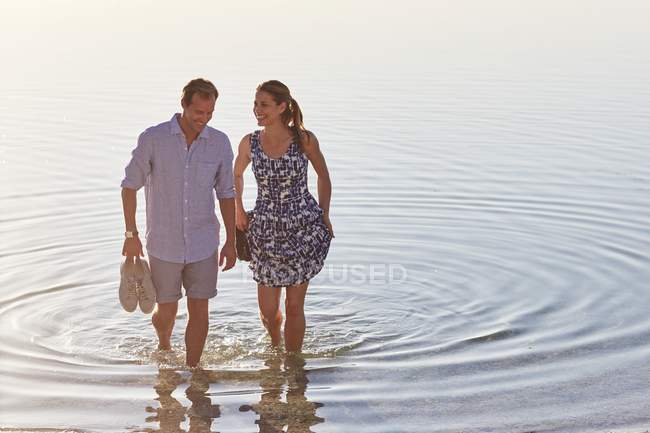 Couple paddling in sea water. — Stock Photo