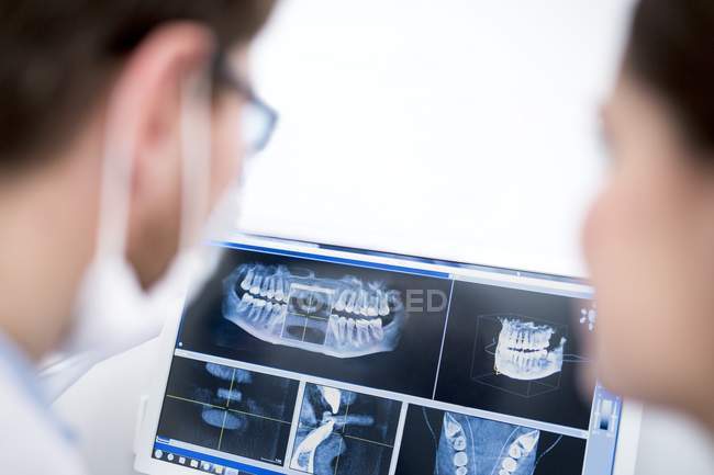Two dentists looking at medical x-ray in hospital. — Stock Photo