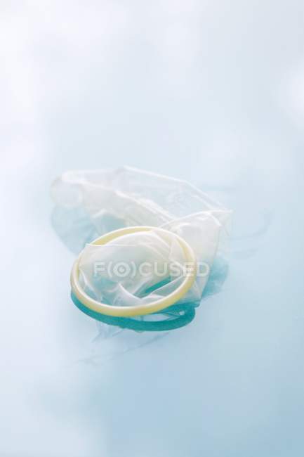 Condom barrier contraceptive is a latex sheath to be rolled over the erect penis before intercourse. — Stock Photo