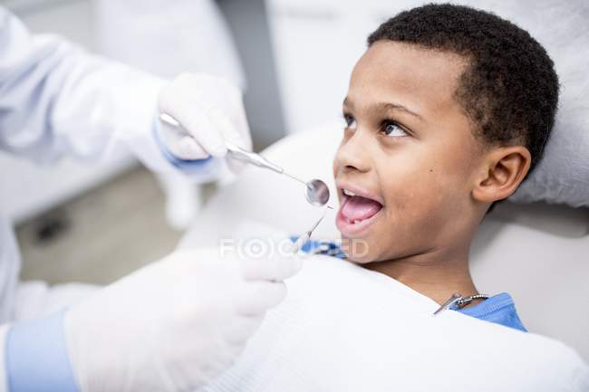 Portrait of boy waiting for teeth examination in clinic. — Stock Photo