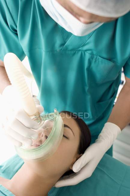 Anaesthetist administering gas to female patient. — Stock Photo