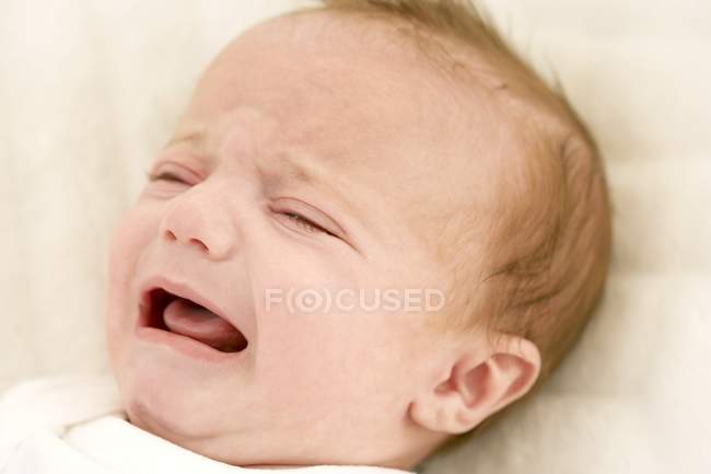 Close-up of crying baby girl. — Stock Photo