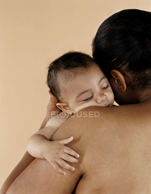 Baby girl sleeping on mother shoulder. — Stock Photo