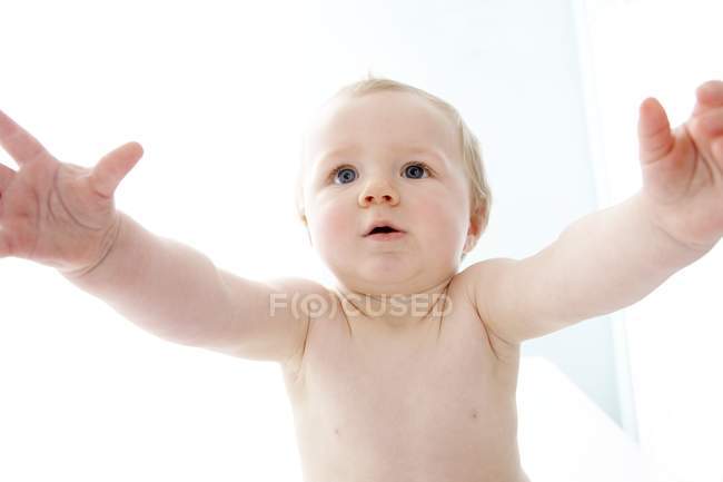 Portrait of baby with arms outstretched. — Stock Photo