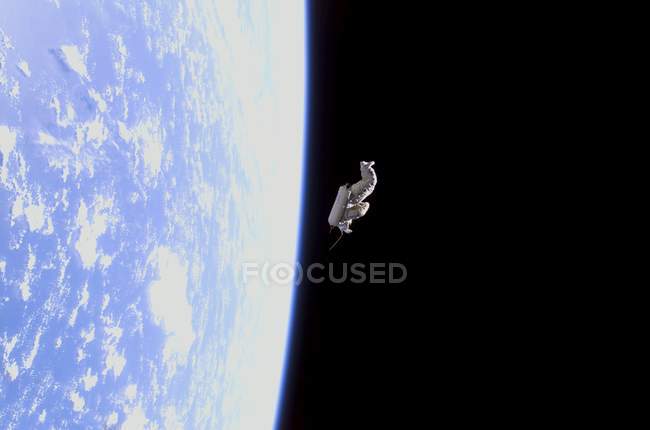 Satellite image of spacesuit on Earth orbit. — Stock Photo