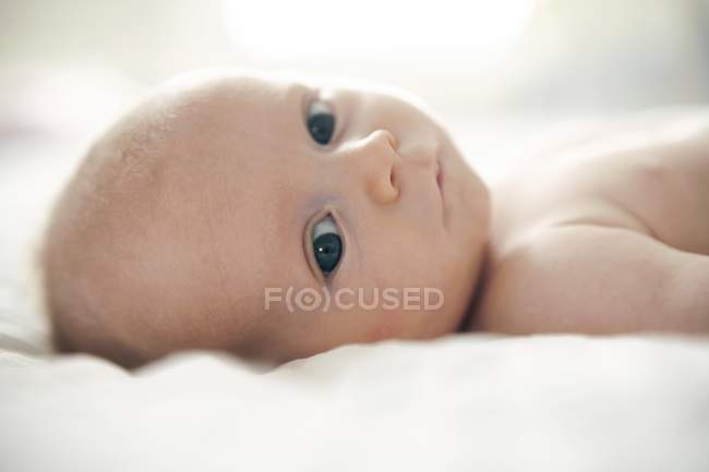 Porträt eines Säuglings, der auf dem Bett liegt. — Stockfoto