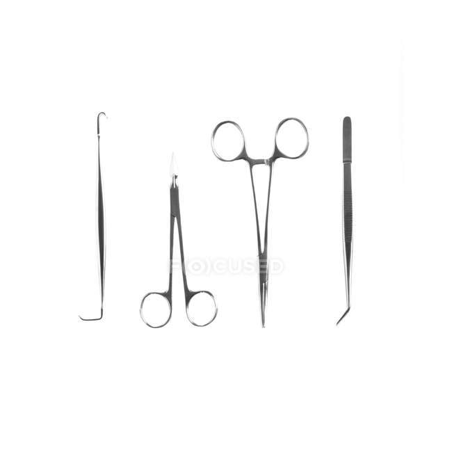 Surgical forceps and hooks on white background. — Stock Photo