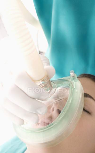 Anaesthetist administering gas to female patient, close-up. — Stock Photo
