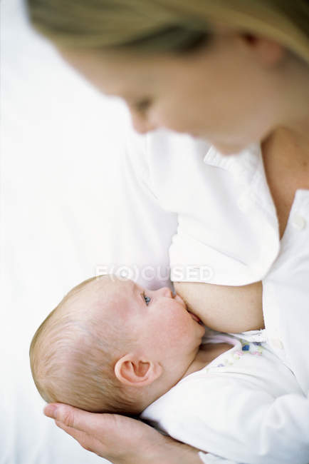 Close-up of mother breastfeeding baby. — Stock Photo