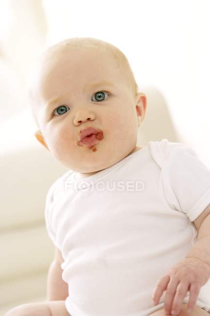 Baby girl with messy mouth. — Stock Photo