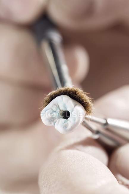 Person making prosthetic tooth, close-up. — Stock Photo