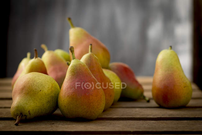 Guyot pears on wooden surface, still life. — Stock Photo