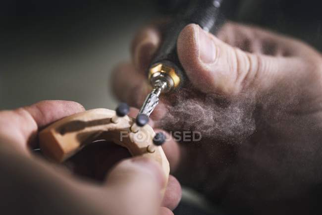 Person making prosthetic teeth, close-up. — Stock Photo