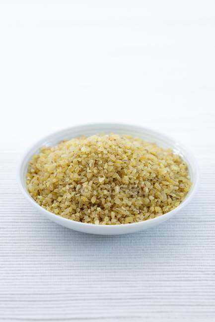 Булгурская пшеница в миске на столе
. — стоковое фото
