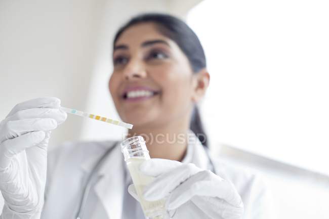 Female doctor testing urine with stick, close-up. — Stock Photo