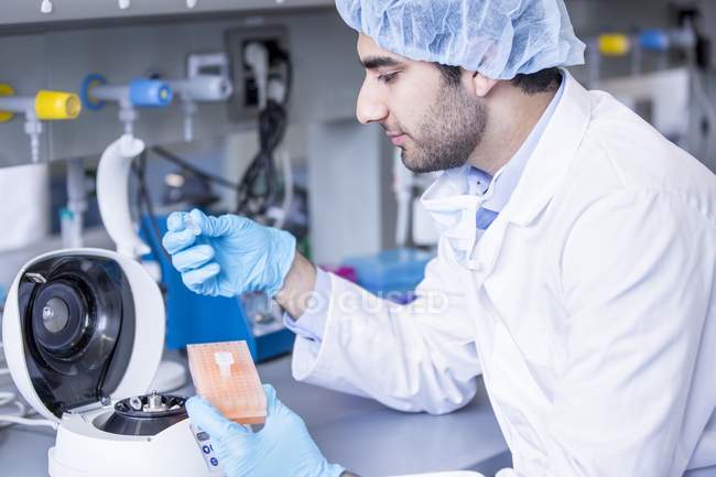 Male scientist in protective clothing working in laboratory. — Stock Photo