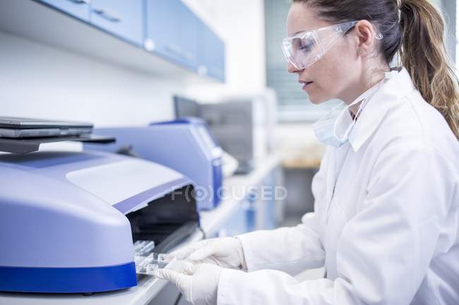 Scienziata che utilizza attrezzature in laboratorio . — Foto stock