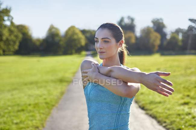 Young woman stretching arms. — Stock Photo