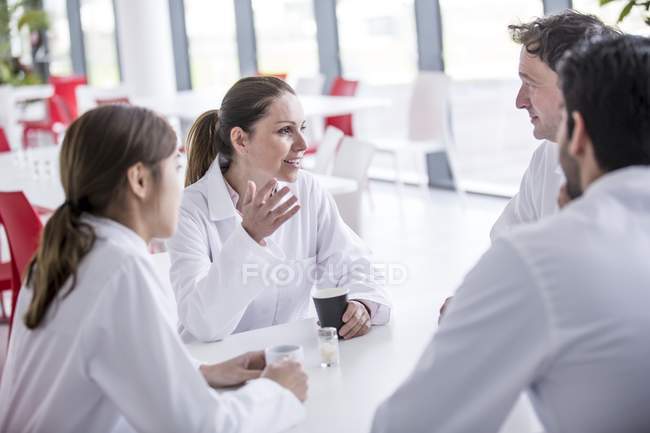 Medical colleagues in canteen relaxing. — Stock Photo