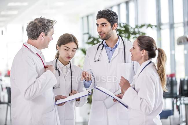 Medical colleagues standing with clip boards. — Stock Photo