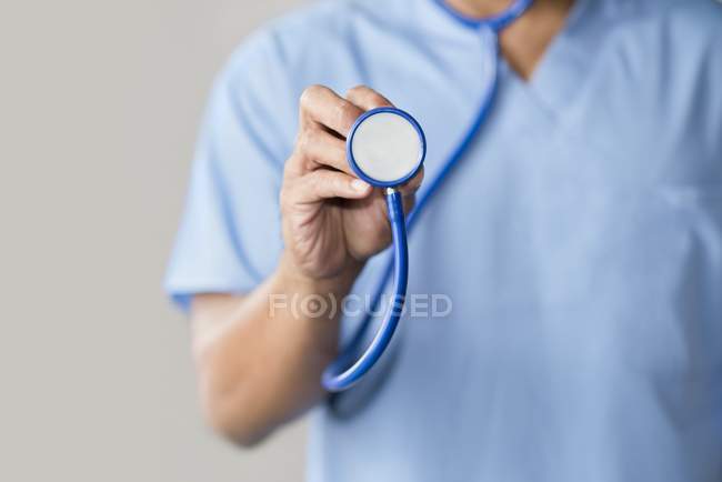 Médico masculino en uniforme azul con estetoscopio . - foto de stock