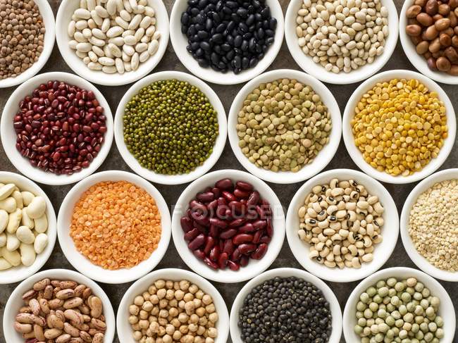 Pulses in white bowls, overhead view. — Stock Photo