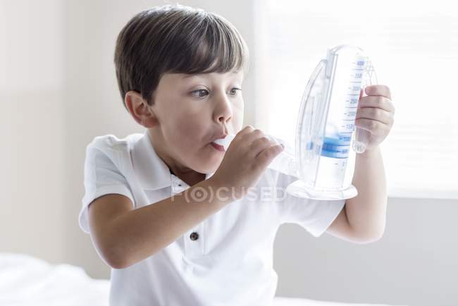 Boy using breathing equipment. — Stock Photo