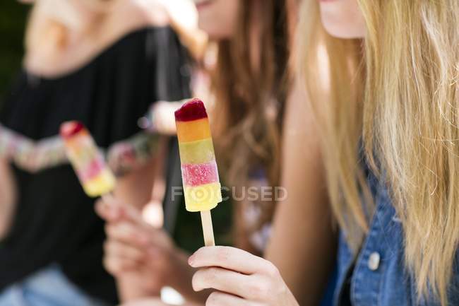 Close-up view of women holding ice pop. — Stock Photo