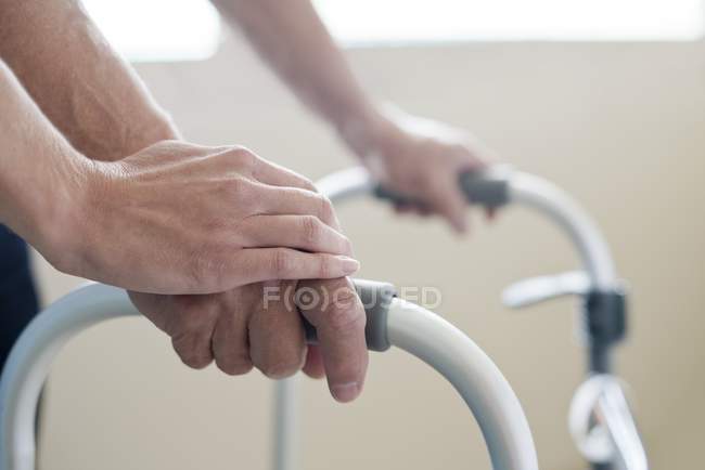 Patient using walking frame, close-up. — Stock Photo