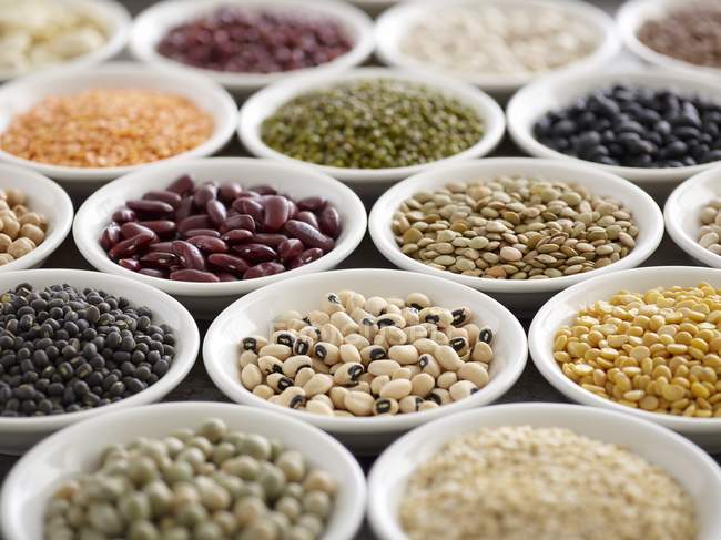 Close-up view of legumes in white bowls. — Stock Photo
