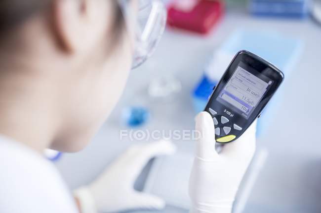 Laboratory assistant using electronic pipette. — Stock Photo