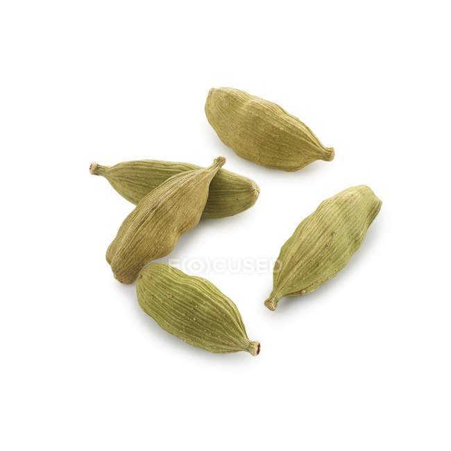 Cardamom seed pods on white background. — Stock Photo