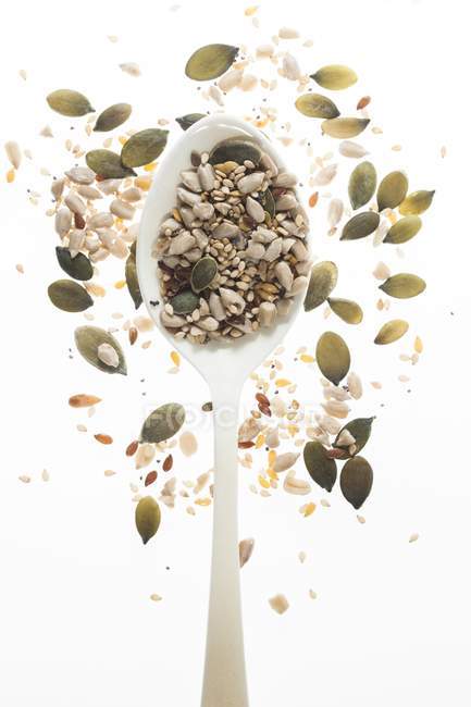 Mixed seeds on spoon, studio shot. — Stock Photo