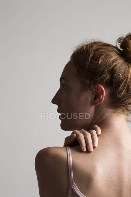 Woman touching neck with hand. — Stock Photo