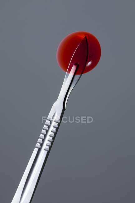 Red spot on surgical scalpel. — Stock Photo