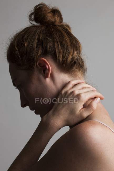 Woman touching neck with hand. — Stock Photo